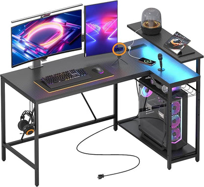 Bestier 52-Inch L-Shaped Gaming Desk with Charging & LED, Black | Charging 3AC+2USB, RGB LED 20 Colors/22 Modes, Reversible Shelves, Carbon Fiber Texture, Headphone Hook, 52 in